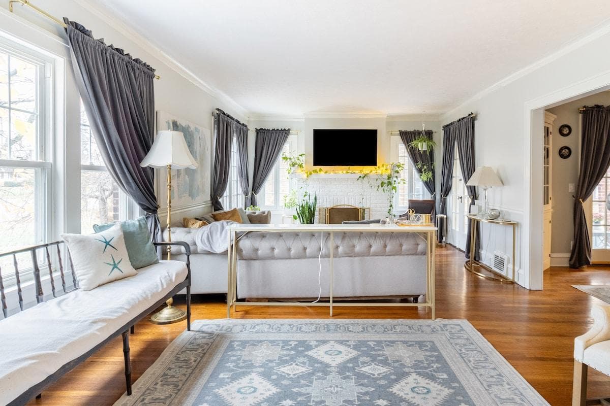 This generous & elevated family room has it all: multiple seating areas, lush black-out curtains, sectional sofa, fluffy blankets, lots of pillows & 55" Smart TV with Roku.  Sign in to your streaming apps to see your favorite shows & movies.